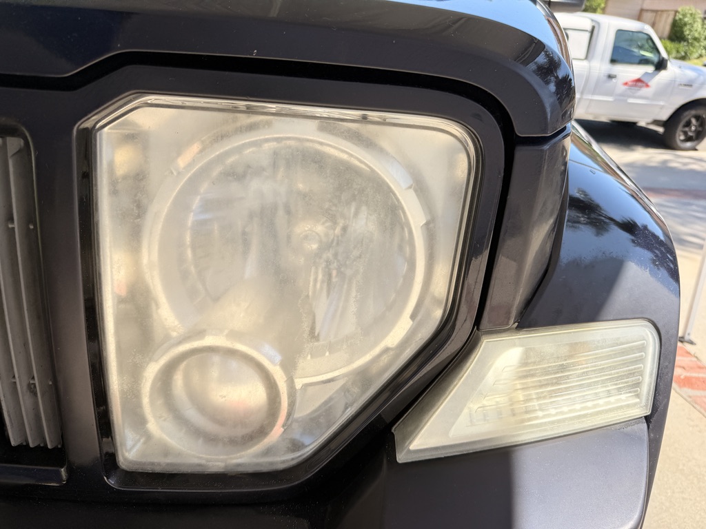 Headlight before restoration — foggy, hazy, and oxidized
