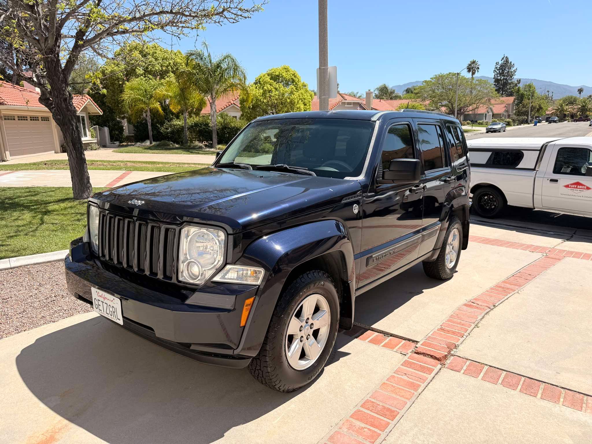 Detailed dark SUV with a deep, protected gloss finish in a driveway