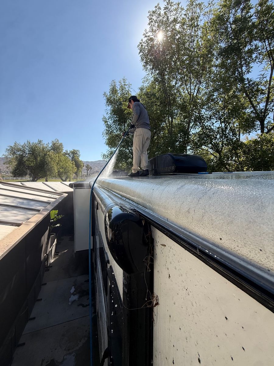 Tuff Bros detailer washing the roof of a motorhome