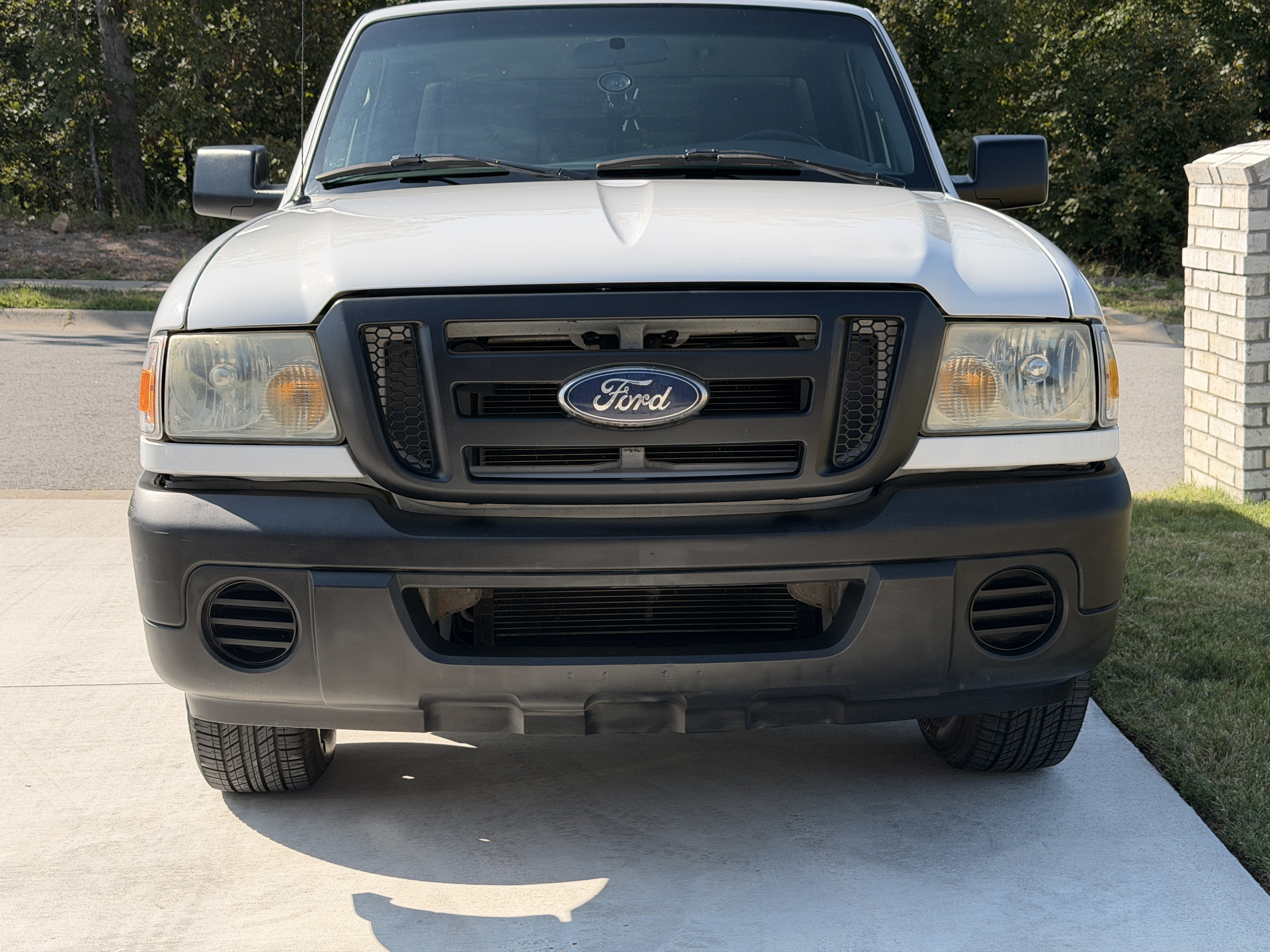 Ford truck with restored deep black front bumper and grille trim