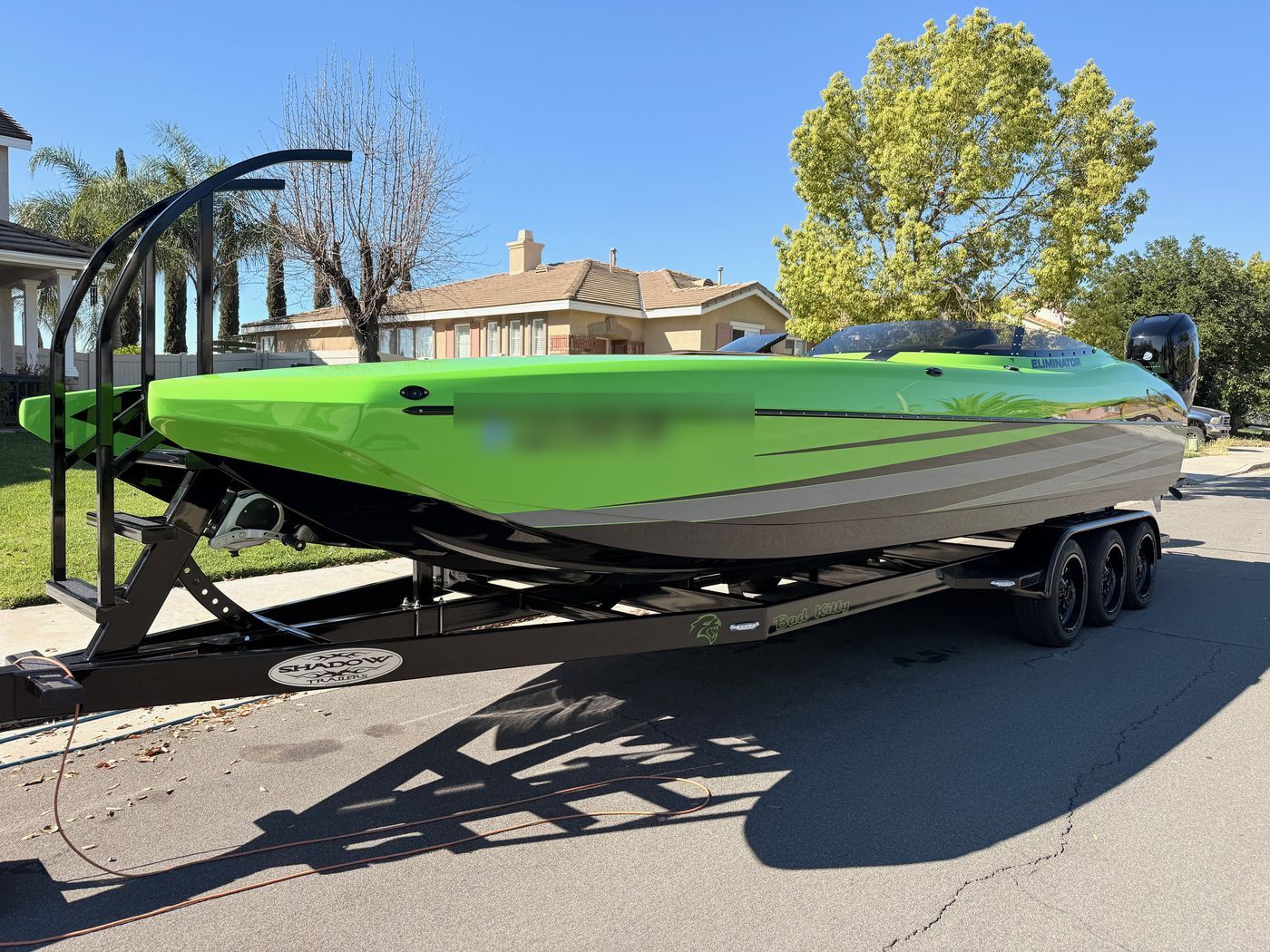 Green speed boat cleaned and detailed on its trailer
