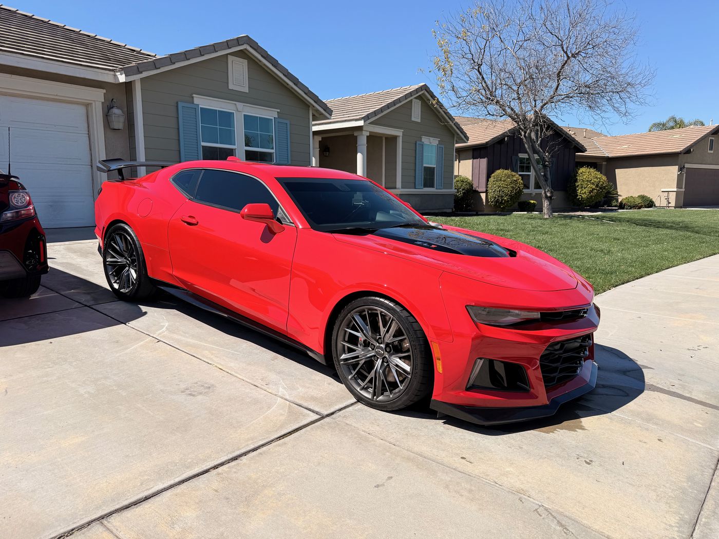 Glossy red Chevrolet Camaro after a full exterior detail